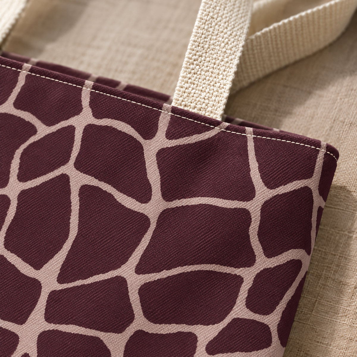 Close-up of the pink giraffe lines on dark brown fabric and the cream handle