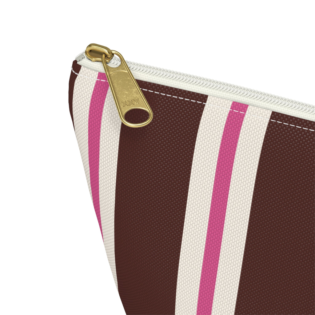 Close-up of the gold zipper pull and brown and pink stripes on the makeup bag