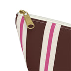 Close-up of the gold zipper pull and brown and pink stripes on the makeup bag