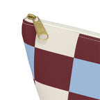 Close-up of the gold zipper pull and checkered squares on the makeup bag
