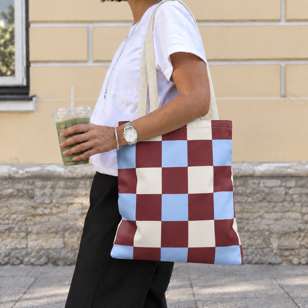 Woman carrying the burgundy blue cream checkered tote bag on her shoulder on the street