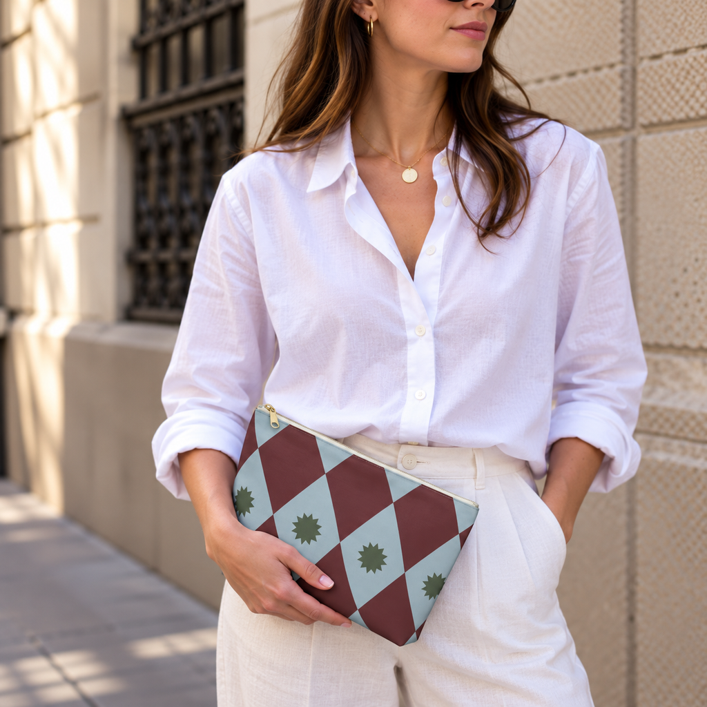 Model in a white shirt holding the burgundy blue diamond makeup bag at her waist