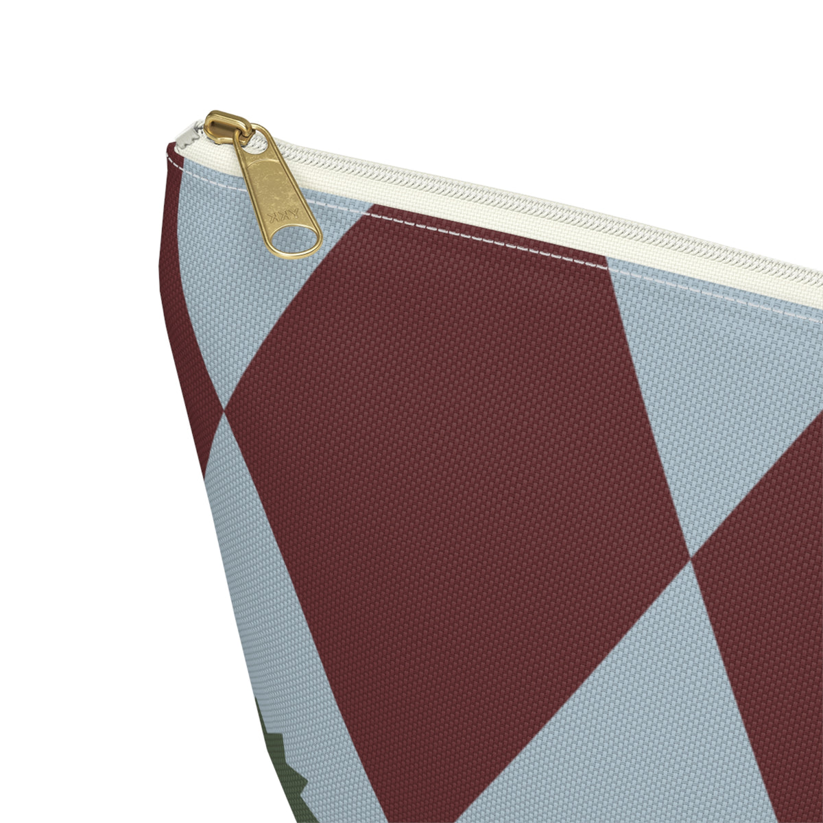 Close-up of the gold zipper pull and burgundy blue diamond print on the makeup bag