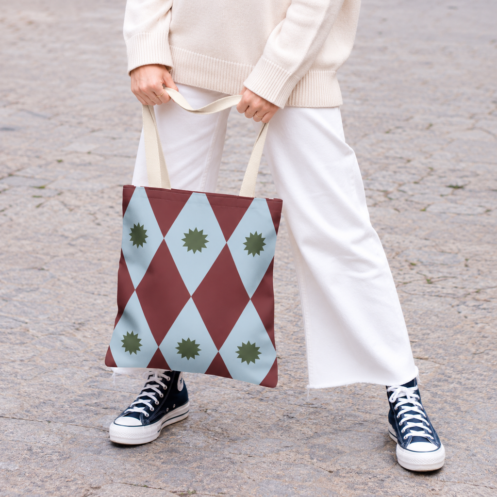Model in white trousers holding the burgundy blue diamond tote bag