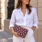 Woman in white shirt holding the burgundy blue geometric makeup bag