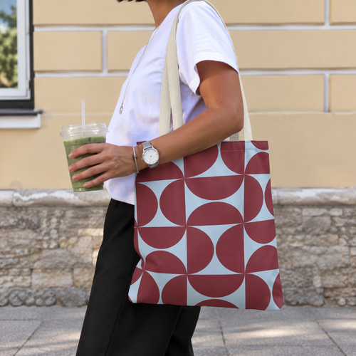 Side view of a person carrying the burgundy blue geometric tote bag on the shoulder