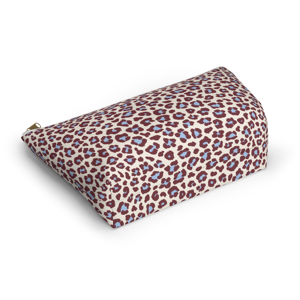 Burgundy and blue leopard print cosmetic bag lying at an angle