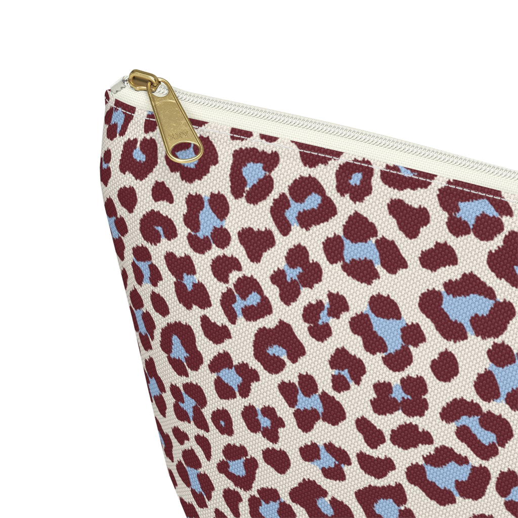 Close-up of the gold zipper pull on the burgundy blue leopard print makeup bag