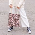 Woman holding the burgundy blue leopard print tote bag in front of her on a street