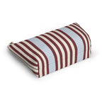 Burgundy blue pinstripe makeup bag lying on its side showing the fine stripes
