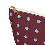 Close-up of the gold zipper pull on the burgundy blue polka dot makeup bag