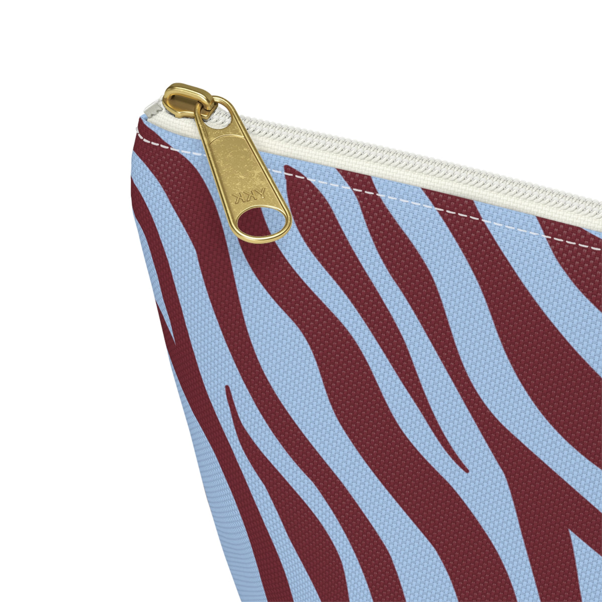 Close-up of the gold zipper pull on the burgundy blue zebra print makeup bag