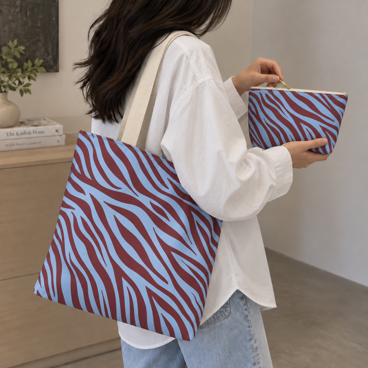 Model carrying the zebra print tote bag on her shoulder with the matching makeup bag in hand
