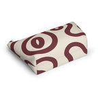 Burgundy cream abstract makeup bag lying flat at an angle