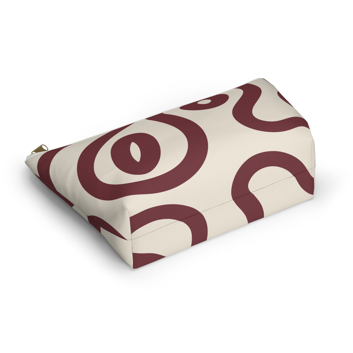 Burgundy cream abstract makeup bag lying flat at an angle