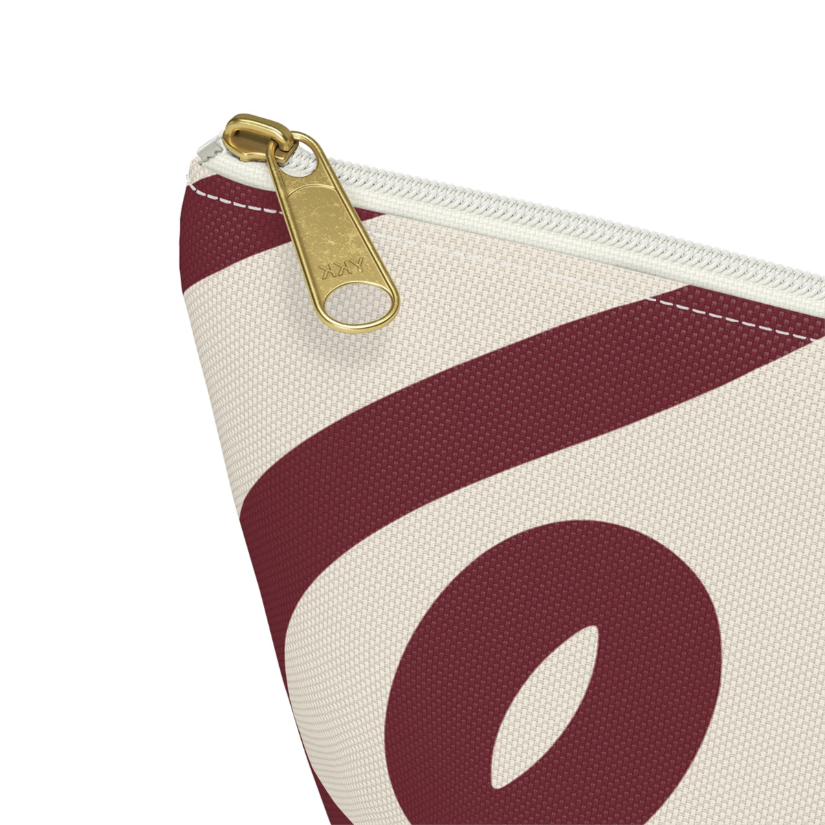 Close-up of the gold zipper pull and burgundy loop print on the makeup bag
