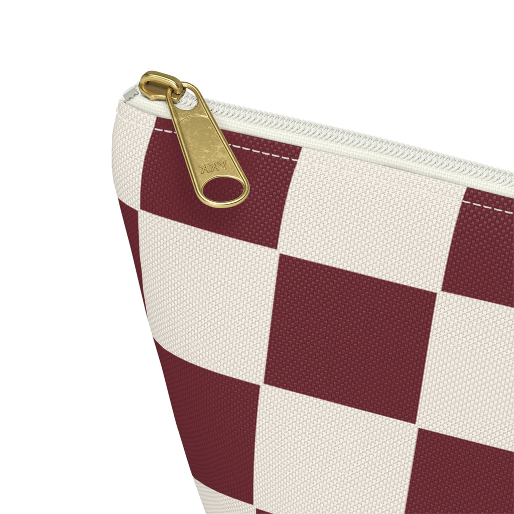 Close-up of the gold zipper pull and checkerboard print on the makeup bag
