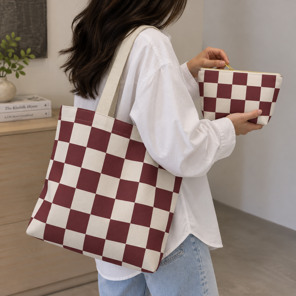 Woman carrying the burgundy cream checkered tote bag with the matching makeup bag in her hand