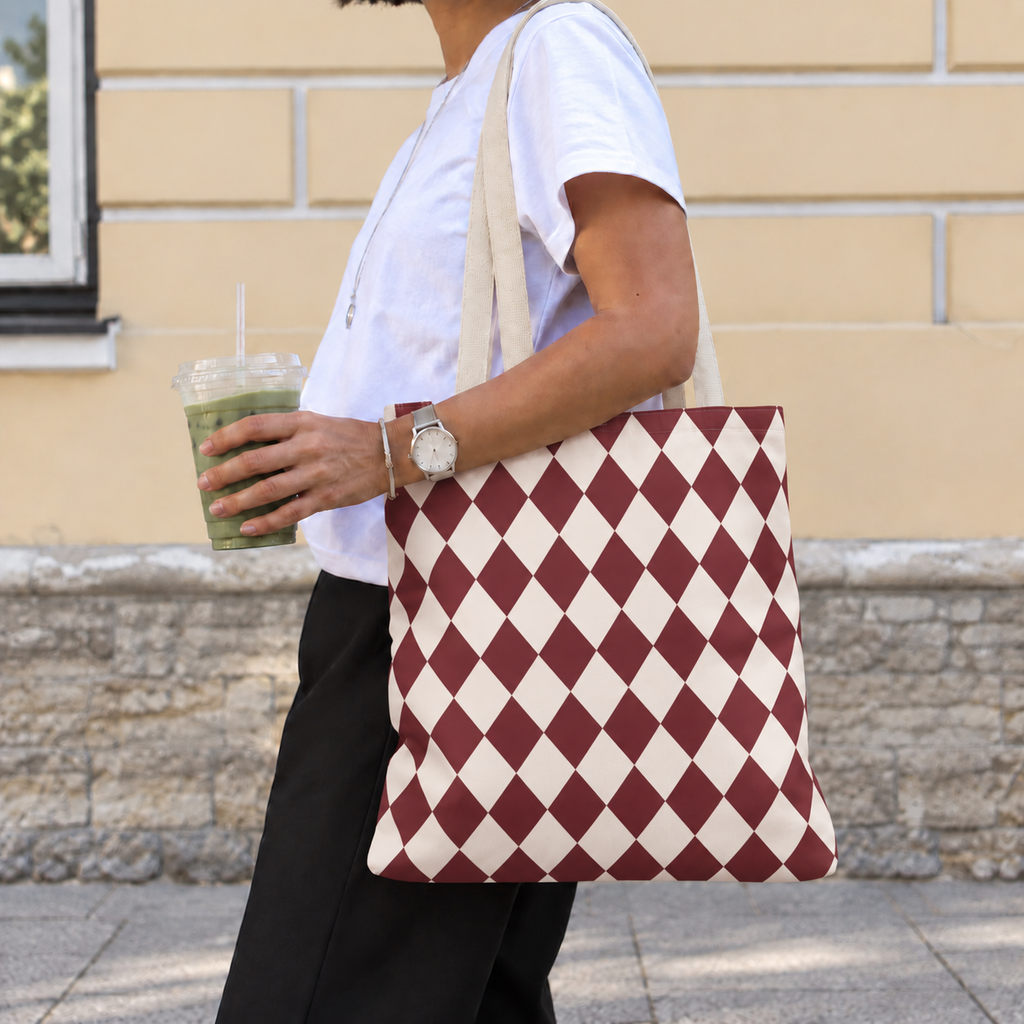 Woman with a burgundy cream diamond checkered tote bag over her shoulder
