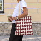 Woman with a burgundy cream diamond checkered tote bag over her shoulder