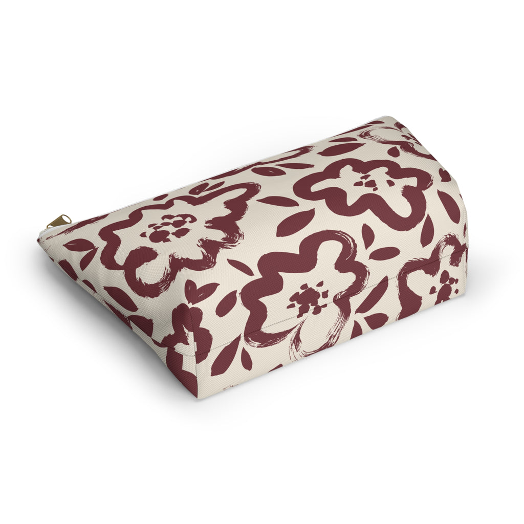 Burgundy cream floral makeup bag lying flat at an angle