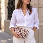 Woman in white shirt holding the burgundy cream floral makeup bag