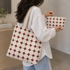 Woman carrying the matching tote bag and Burgundy Cream Geometric makeup bag