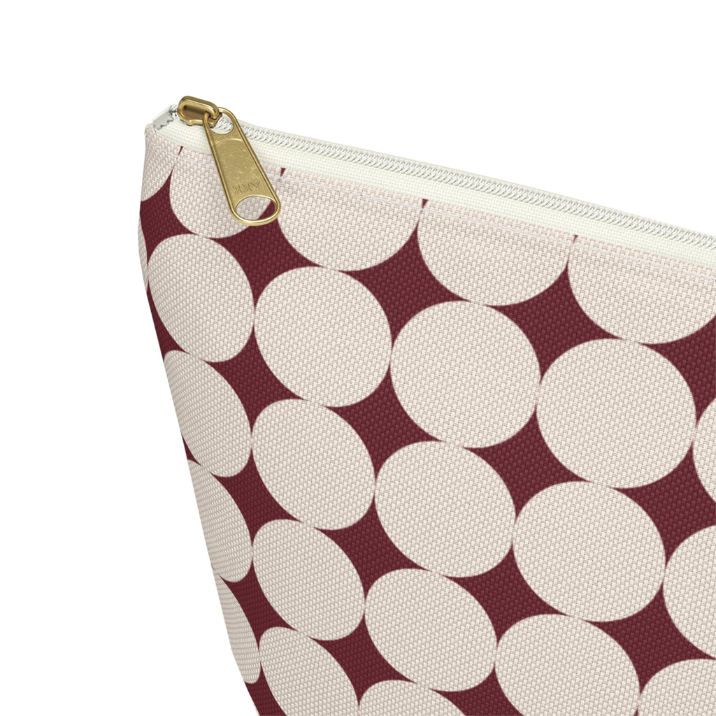 Close-up of the cream circle print and gold zipper pull on the makeup bag