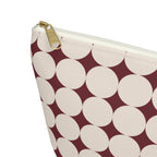 Close-up of the cream circle print and gold zipper pull on the makeup bag