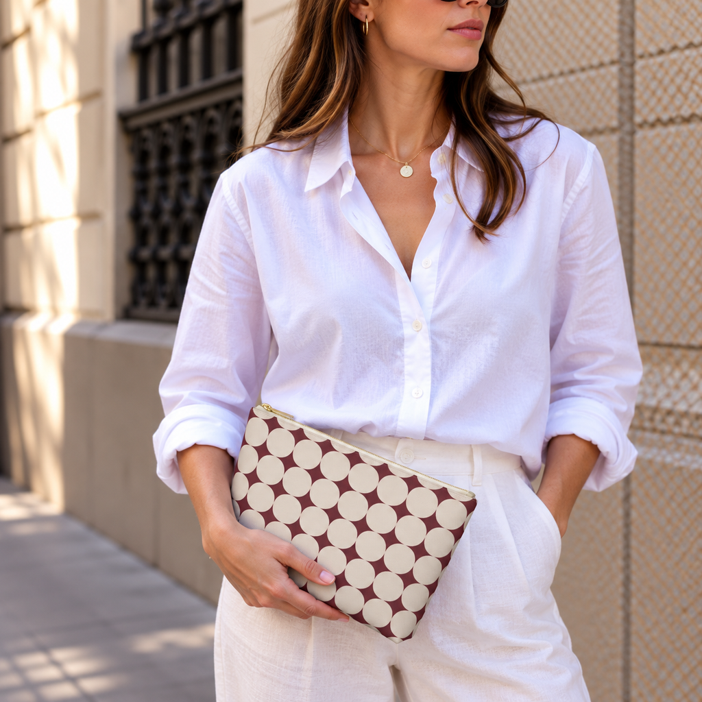 Model holding the Burgundy Cream Geometric makeup bag like a clutch