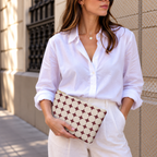 Model holding the Burgundy Cream Geometric makeup bag like a clutch