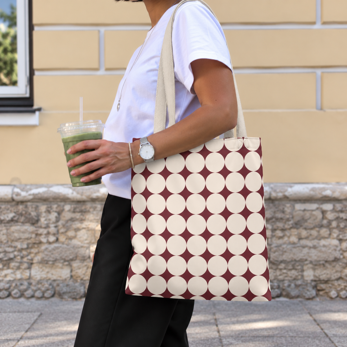 Model styled with the Burgundy Cream Geometric tote bag on her shoulder outdoors