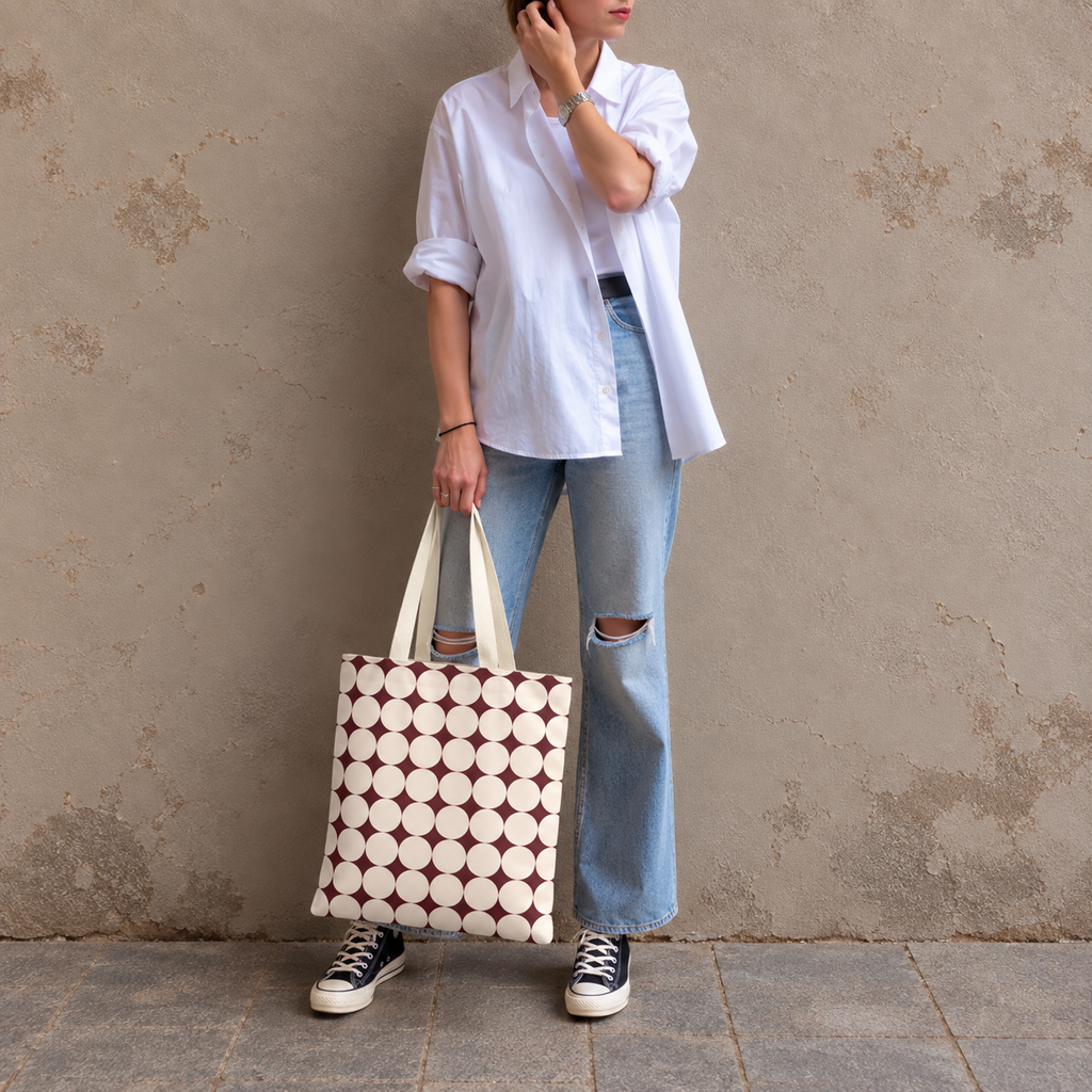 Full-length model photo with the retro Burgundy Cream Geometric tote bag against a wall