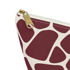 Close-up of the gold zipper pull and burgundy giraffe patches on the makeup bag