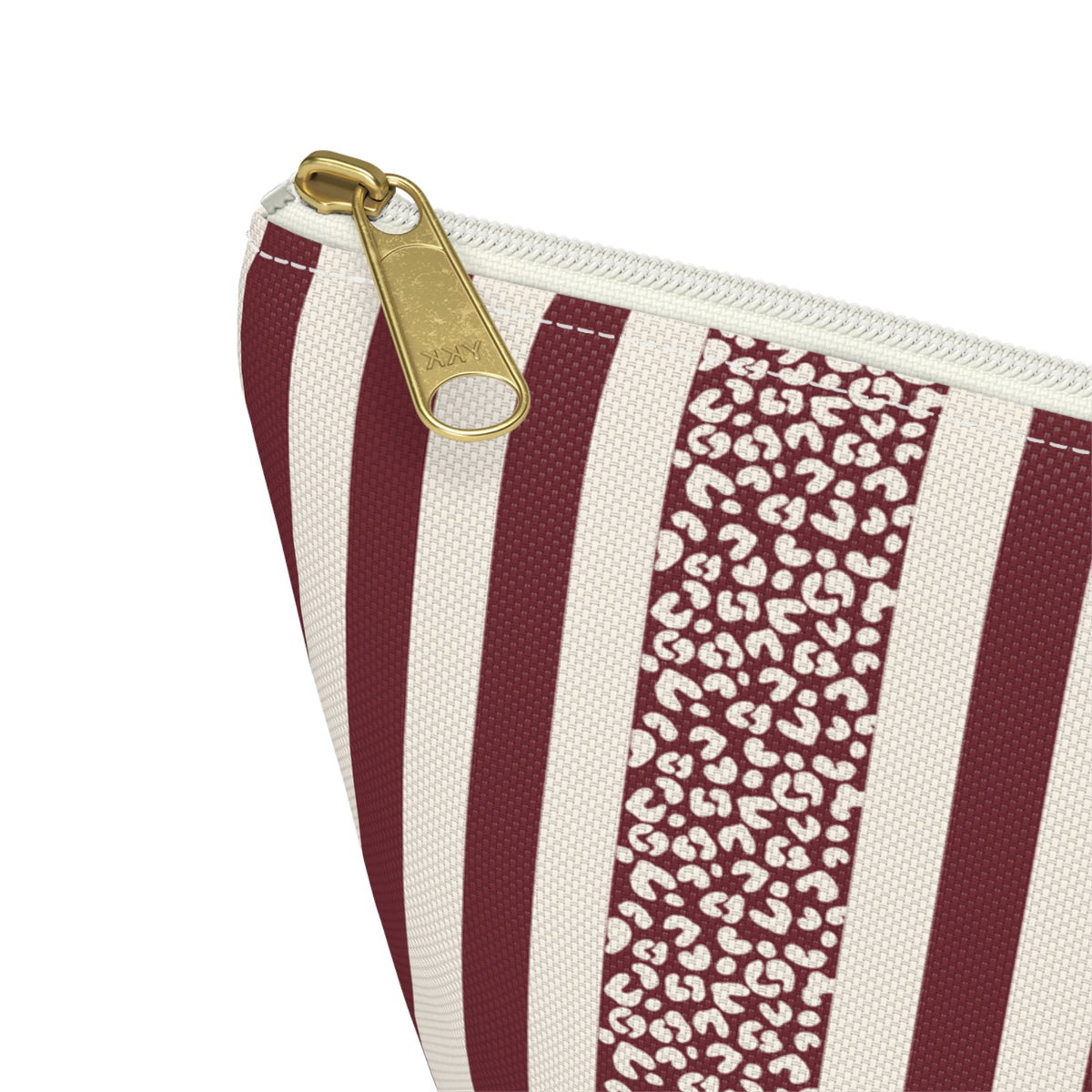 Close-up of the gold zipper pull, burgundy stripes and leopard spot panel