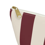 Close-up of the gold zipper pull and burgundy stripe on the makeup bag