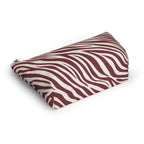 Burgundy zebra print cosmetic bag lying at an angle