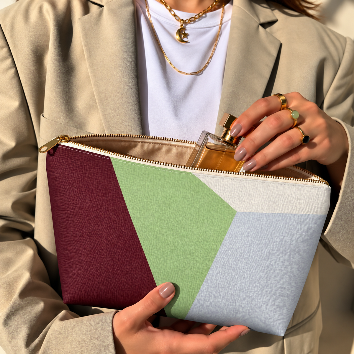 Model opening the color block makeup bag to take out a perfume bottle