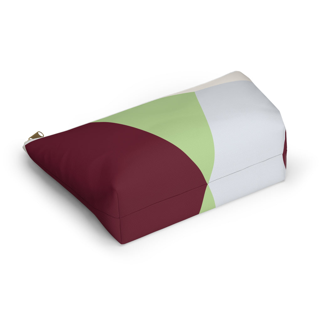 Color block makeup bag lying on its side showing burgundy, sage green and cream panels