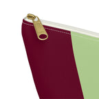 Close-up of the gold zipper pull on the burgundy and green color block makeup bag