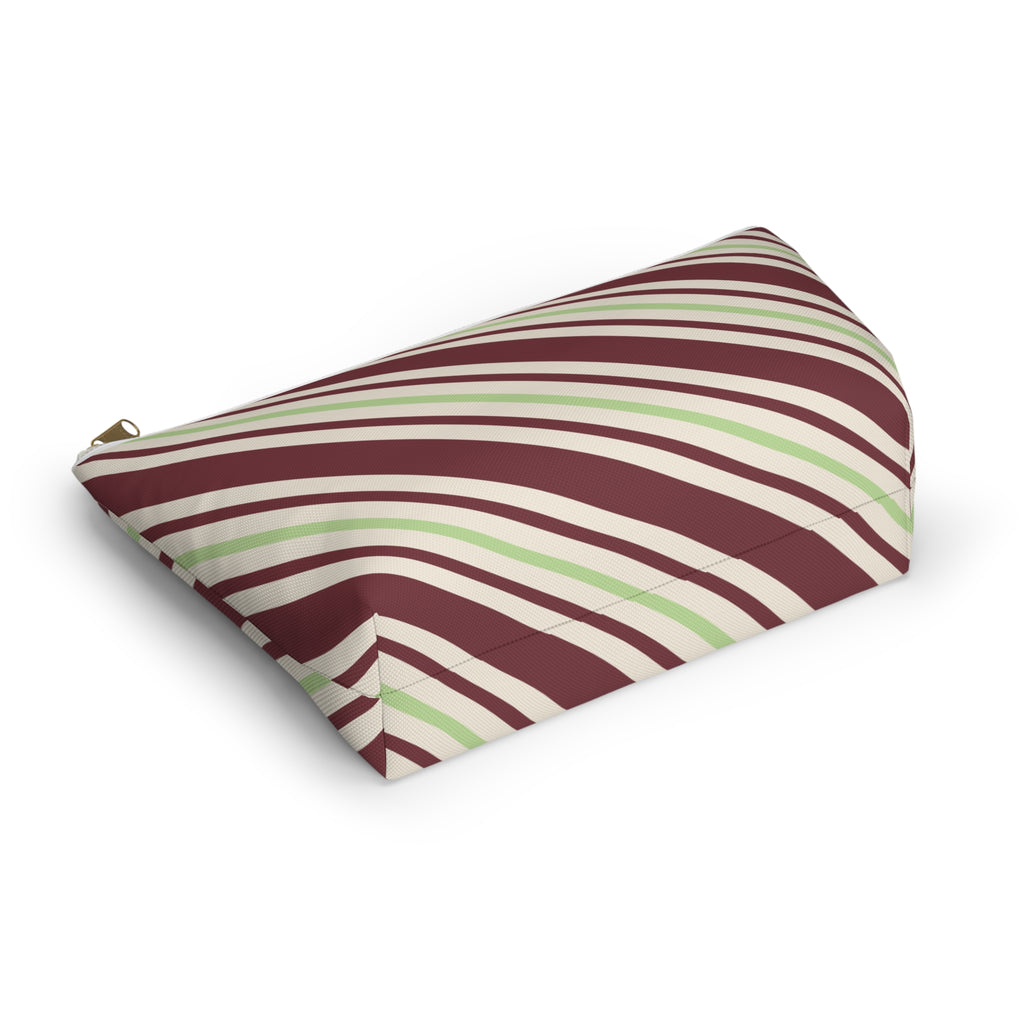 Burgundy and green striped cosmetic bag lying on its side
