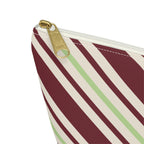 Close-up of the gold zipper pull on the diagonal striped makeup bag