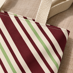 Close-up of the burgundy, sage green and cream diagonal stripes on the tote bag