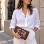 Woman in a white shirt holding the Burgundy Green Monogram personalized makeup bag
