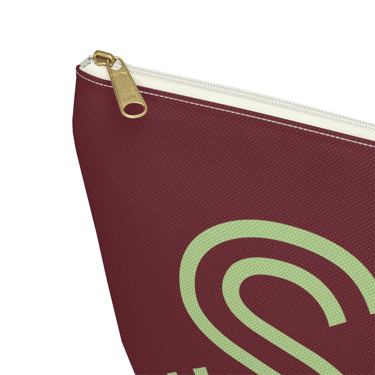 Close-up of the gold zipper pull on the Burgundy Green Monogram personalized makeup bag