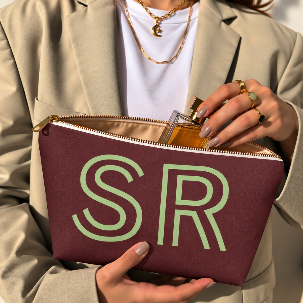 Hands holding the open Burgundy Green Monogram personalized makeup bag