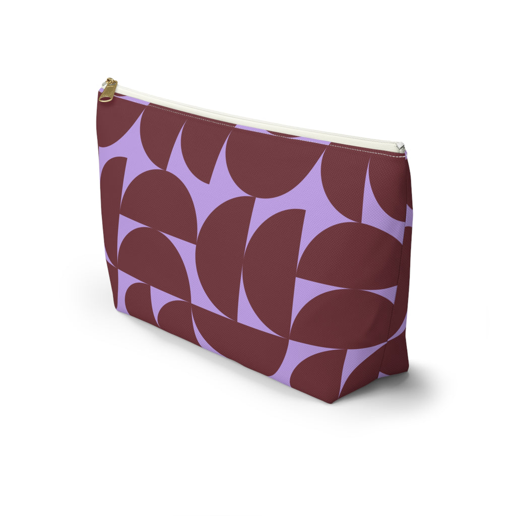 Side view of the burgundy lilac half circle makeup bag with flat T-shaped bottom