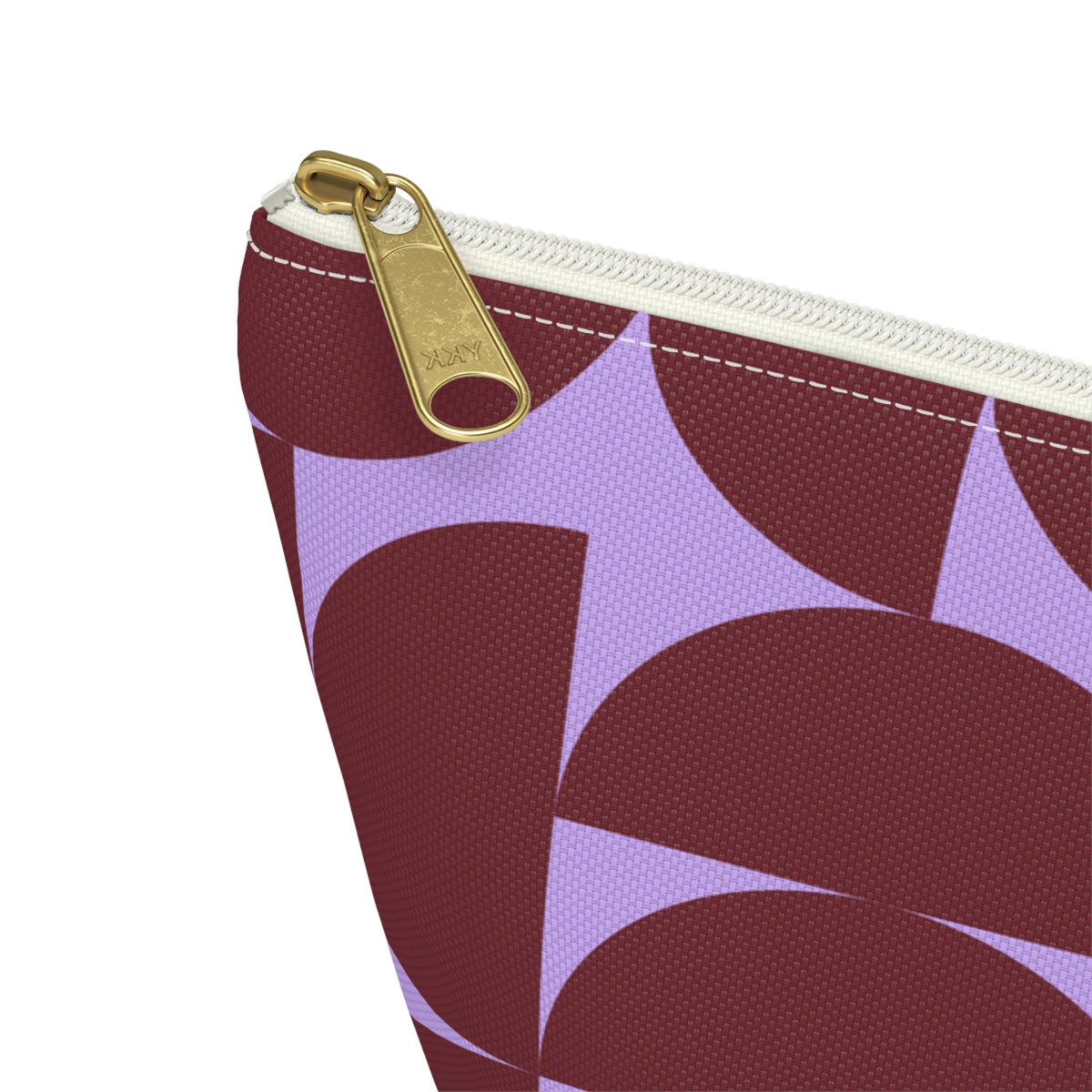 Close-up of the gold zipper pull on the burgundy lilac half circle makeup bag