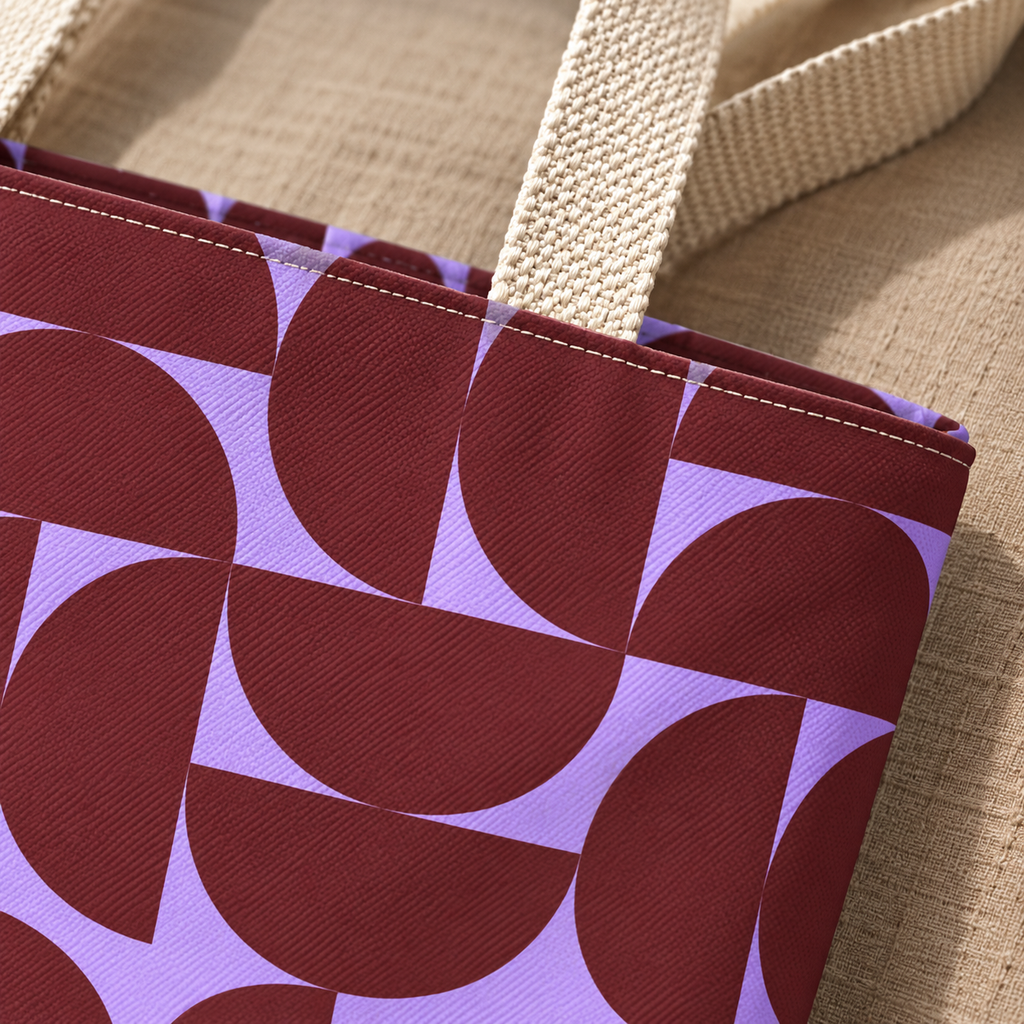 Close-up of the burgundy half circles on lilac with beige handle on the tote bag