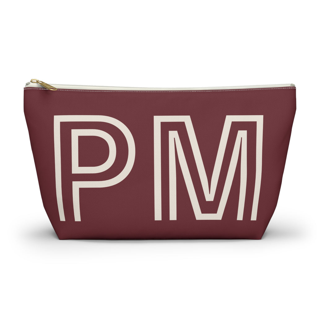 Burgundy monogram personalized makeup bag with cream outlined initials and gold zipper pull